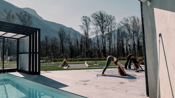 Un espace piscine extérieur moderne offrant une vue dégagée sur les montagnes en arrière-plan.