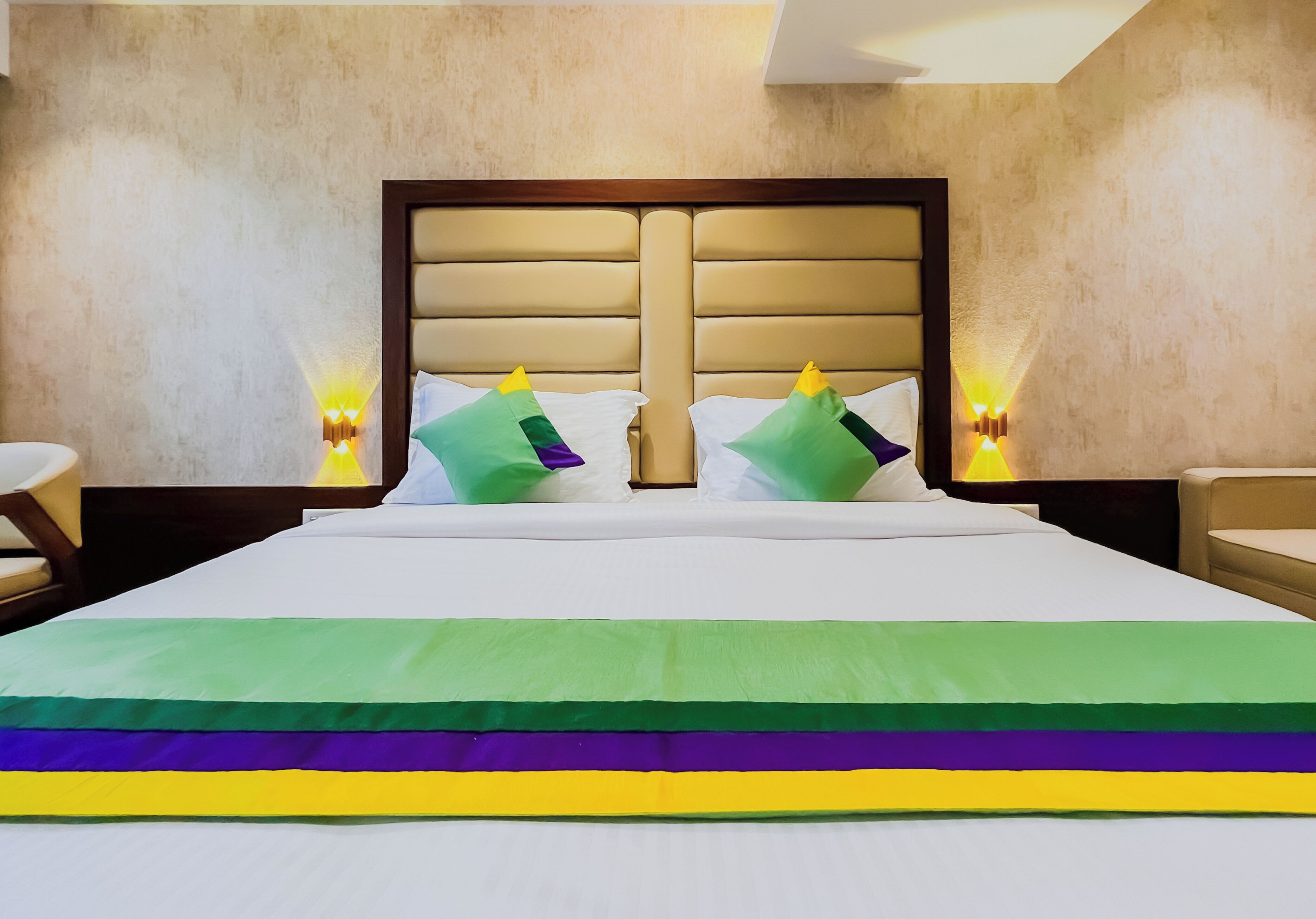 A hotel room with a large bed, two nightstands, and a headboard.