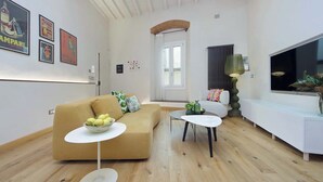 A modern living room with a sofa, coffee table, and TV stand. - Santa Croce Gem w/ Chic Decor & Historic Charm (Florence)