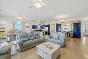 A spacious living area with two grey sofas, a white coffee table, and a ceiling fan. - SAILMAKER 901 - Ole River Views -NO HASSLE CHECK OUT (Pensacola)