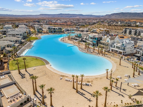 Relax by the resort's large, curved pool surrounded by a sandy beach area and enjoy the views of the desert and distant mountains.
