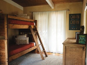 A bunk bed with a ladder, a wooden desk, and a sign that reads 'Cabin sweet Cabin'. - Pike National Forest Cabin with Mountain Views, Deck & Wood Fireplace (Woodland Park)