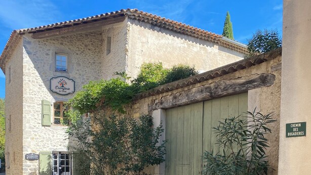 A stone building with a tiled roof, a green door, and a sign indicating a restaurant. - Orangerie de Cardet B&B (Cardet)