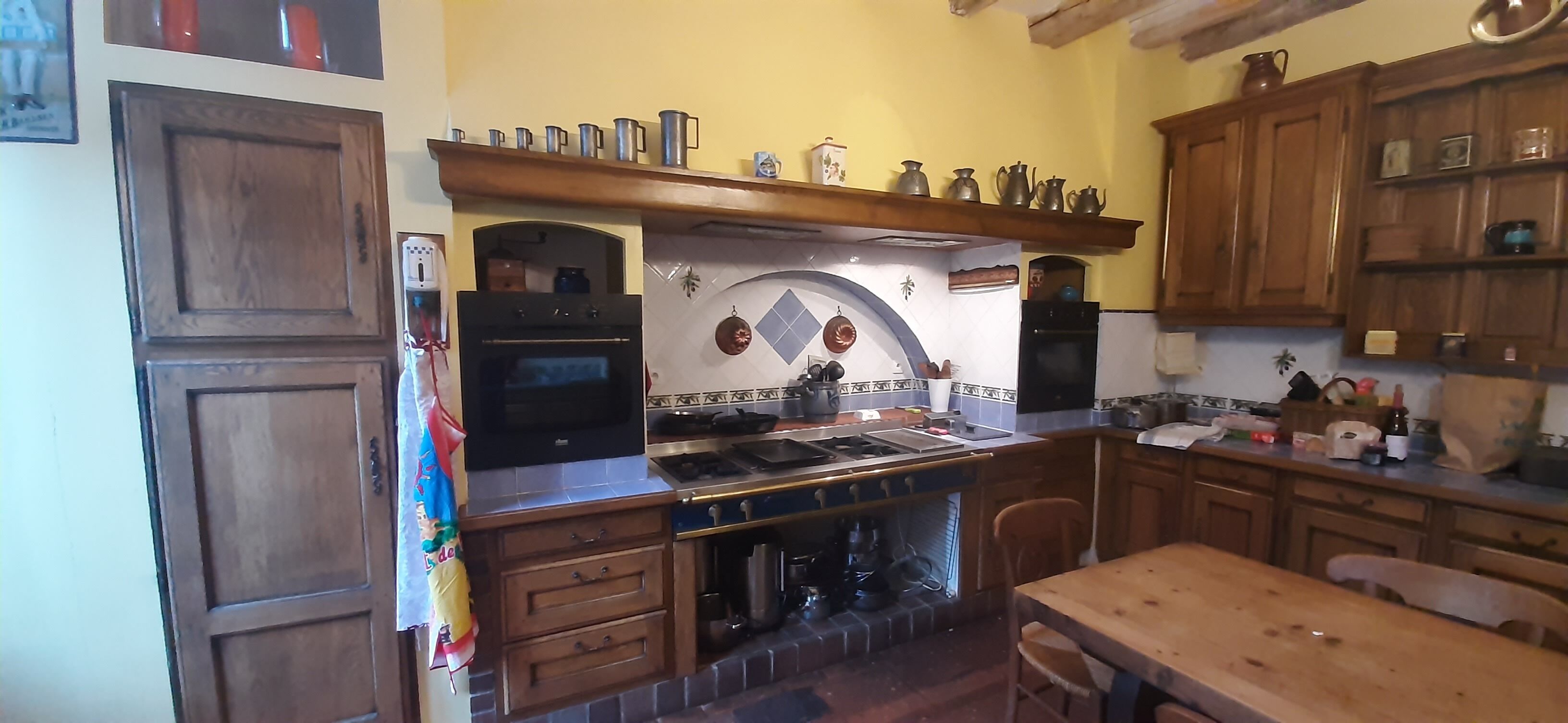 A kitchen with wooden cabinets, a stove, and a microwave.