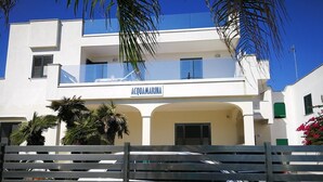 A modern building with balconies and a sign reading "ACQUAMARINA". - Acquamarina (Melendugno)