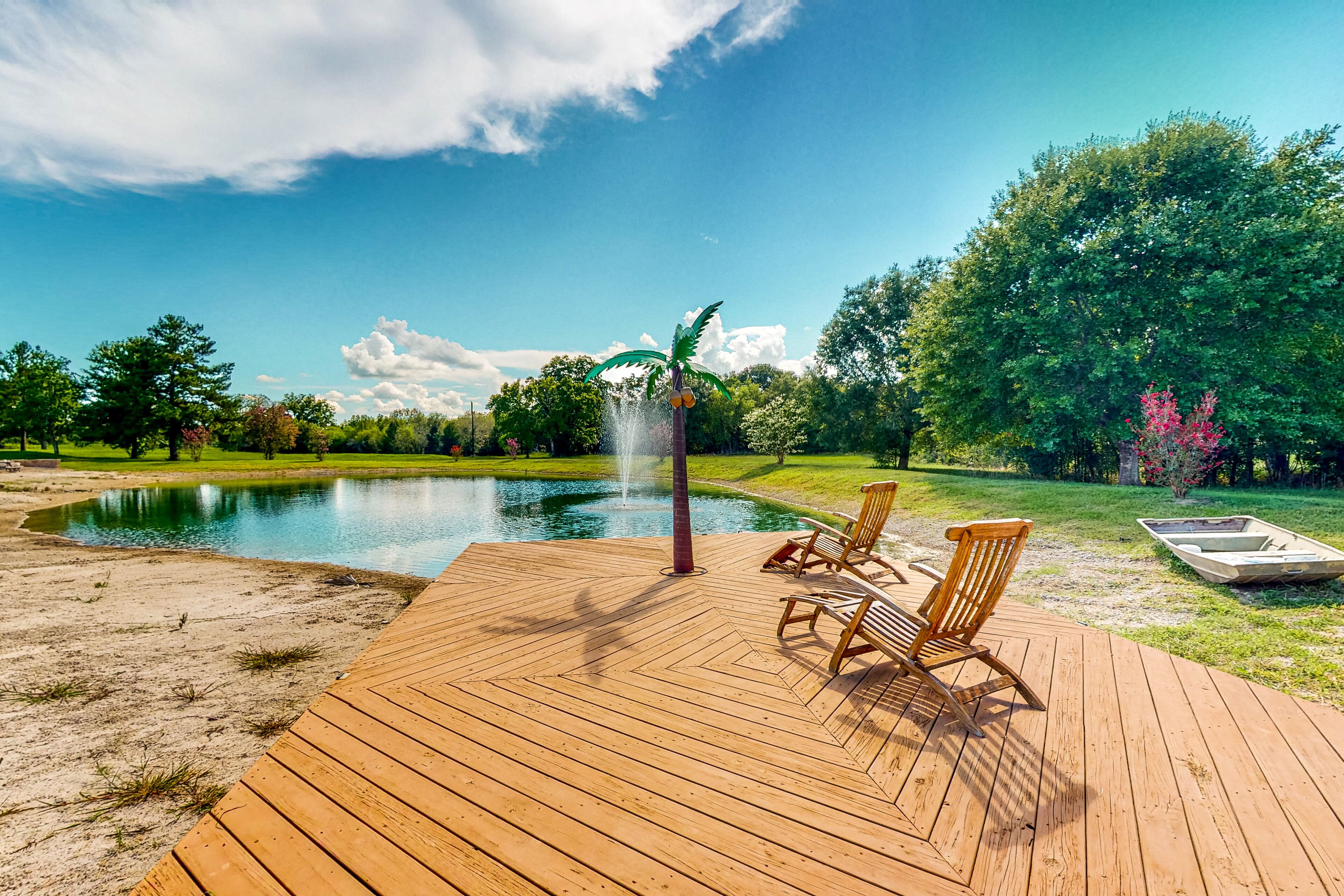 Custom home with guesthouse, pond, sunning deck, beach & tropical bar