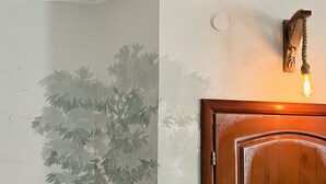 A wooden door with a light fixture above it.