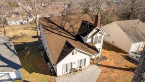 A single-story house with a sloped roof, a front porch with two chairs, and a garage. - EverStay Duplex “Suite B” Close to Everything  (charlotte)