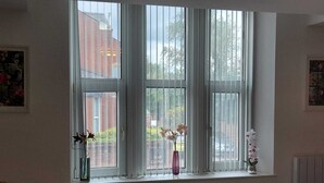 A room with a large window, a small table, and a chair. - Charming 1-bed Studio in Preston (Preston)