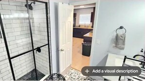 A bathroom with a shower, a toilet, and a sink.