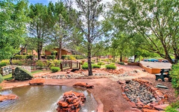 Surrounded by lush greenery and a serene pond, this tranquil oasis offers a peaceful escape.