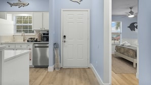 A kitchen with white cabinets, a stainless steel dishwasher, and a coffee bar. - Fall Special! 3BR - Walk to Beach, Private Yard, Fire Pit, Dog Friendly! (Panama City Beach)