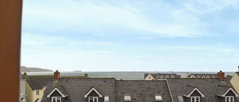 A row of terraced houses with a view of the sea.