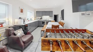 A modern kitchen with a dining area, a foosball table, and a flat-screen TV. - 4 bedroom accommodation in Coxhoe, nearby Durham (Coxhoe, nearby Durham)
