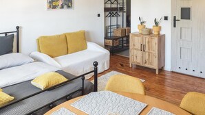 A cozy room with a bed, a wooden cabinet, and a table with placemats.