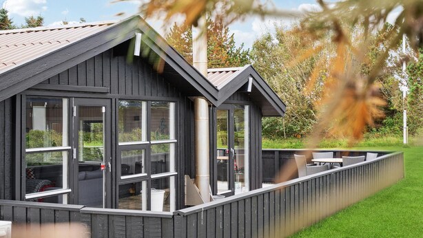 A modern building with large windows and a covered outdoor seating area. - 3 bedroom pet friendly home in Hjørring (Hjørring)