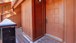 A wooden door with a number plate, a metal handle, and a small window above it. - Condo close to the Chile Express (Angel Fire)