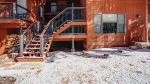 A multi-story wooden building with a staircase leading to the upper floors. - Condo close to the Chile Express (Angel Fire)
