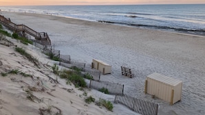 A beach with a wooden staircase leading down to the shore, a bench, and a small wooden structure. - BEAUTIFULLY DECORATED ~ CLOSE TO THE BEACH ~ 5 BEDROOM/4 BATH  (Corolla)
