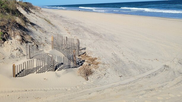 A sandy beach with a wooden fence and a clear blue sky. - "Seas the Day", located in the heart of beautiful Corolla, Outer Banks of NC (Corolla)