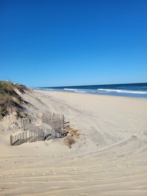A sandy beach with a wooden fence and a clear blue sky. - "Seas the Day", located in the heart of beautiful Corolla, Outer Banks of NC (Corolla)
