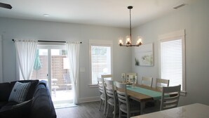 A dining area with a table, chairs, and a chandelier. - "Seas the Day", located in the heart of beautiful Corolla, Outer Banks of NC (Corolla)
