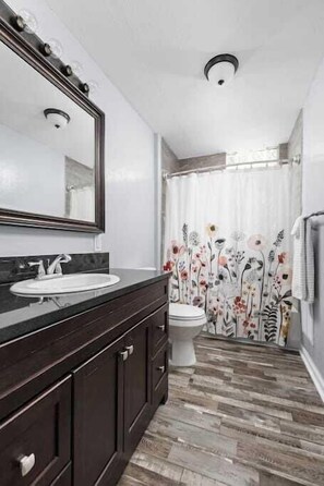 Bathtub, hair dryer, towels, shampoo