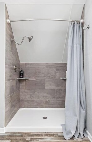 Bathtub, hair dryer, towels, shampoo