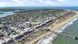 An aerial view of a coastal town with a beach, a pier, and a dense cluster of buildings. - Brand New Tybee Beach Home: Walk to Beach (Unit A) (Tybee Island)