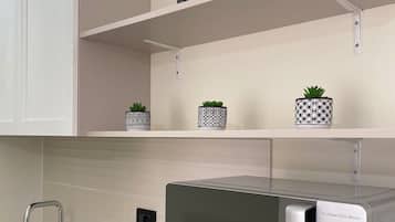 Deluxe Quadruple Room | Private kitchen | Full-sized fridge, microwave, stovetop, electric kettle