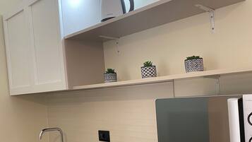 Deluxe Suite, 1 Queen Bed | Private kitchen | Full-size fridge, microwave, stovetop, electric kettle