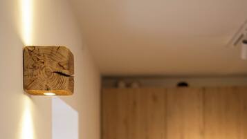 A kitchen with wooden cabinets and a light fixture on the wall.