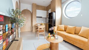 A modern living space with a kitchen, dining area, and a sofa. - Crescendo Boutique Studio  (Hanoi)