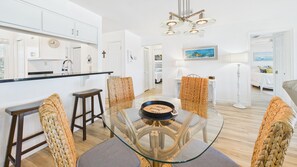 Relax in this stylish living space with a central dining table and comfortable seating.
