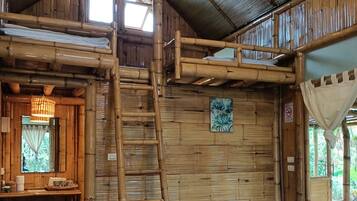 Cozy retreat with a lofted sleeping area, seating space, and a large window.