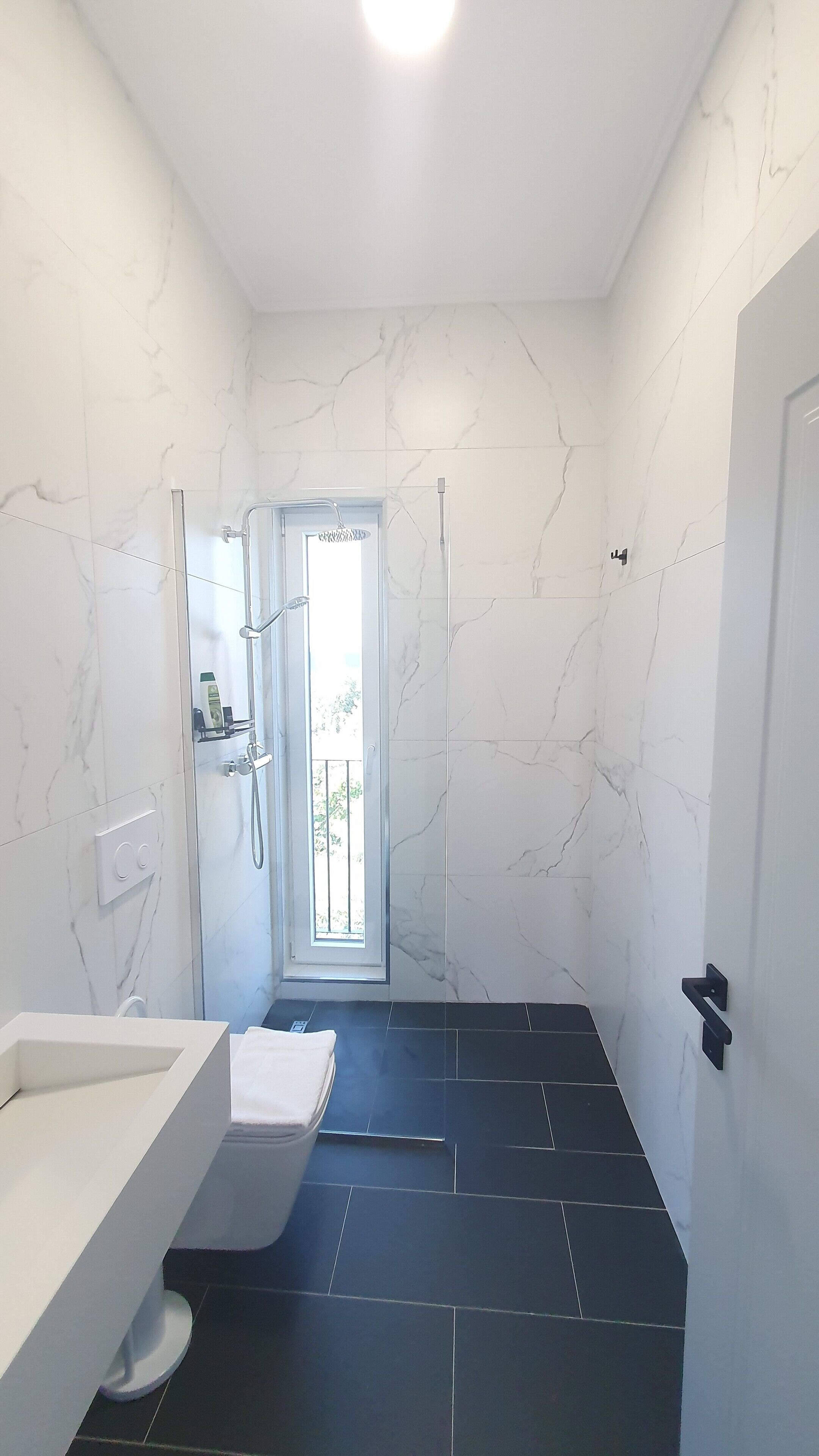 standard room | bathroom | shower, rainfall showerhead, hair dryer, slippers