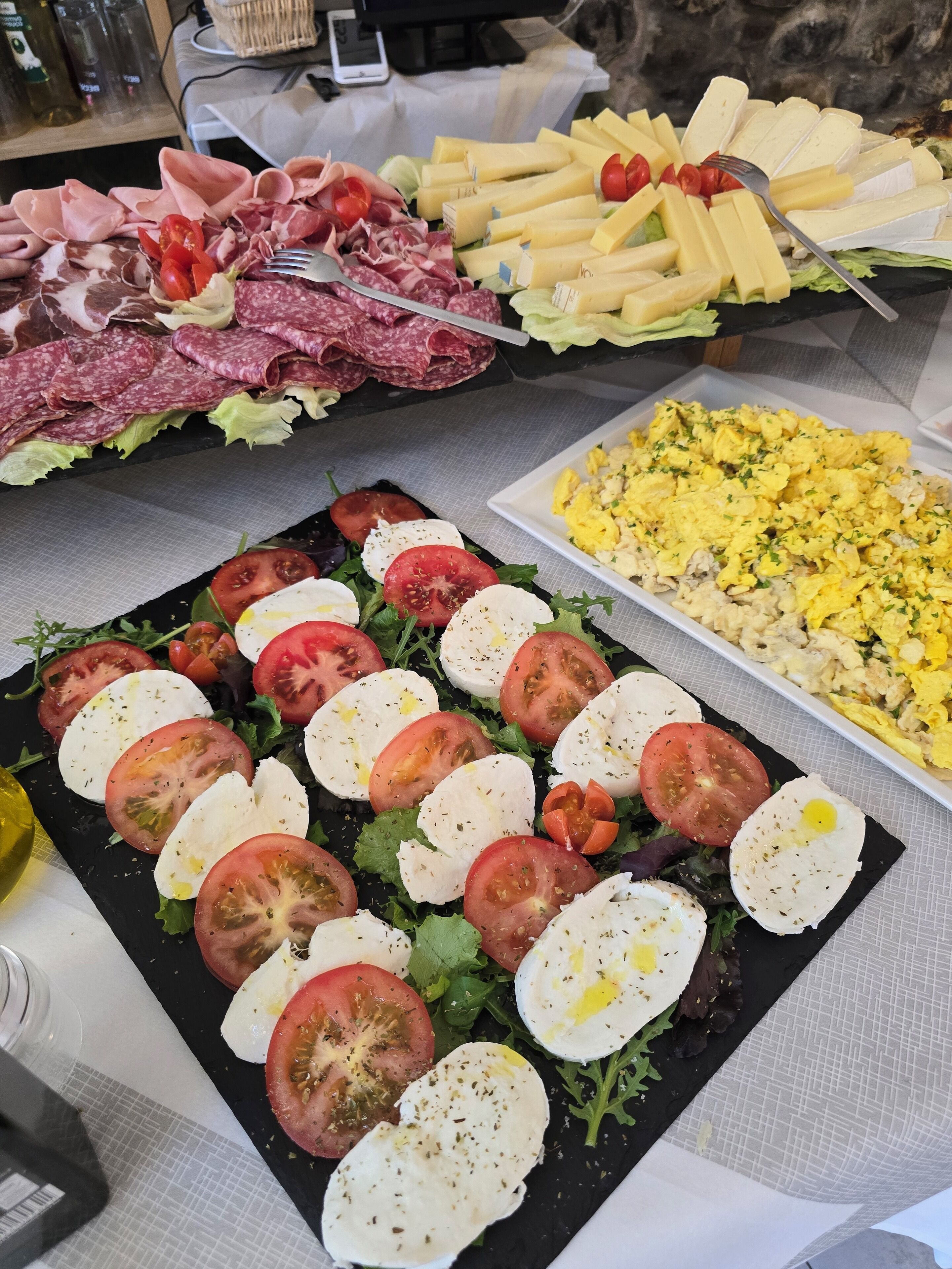 A buffet with various food options including meats, cheeses, and salads.