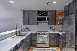 A modern kitchen with stainless steel appliances, a dishwasher, and a built-in oven.