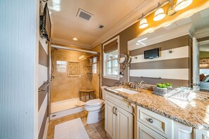 A modern bathroom with a walk-in shower, a toilet, and a vanity with a sink and mirror. - Spacious 5-Bed, 3-Bath Corner Condo, Steps to Beach, Boardwalk & Downtown! (Ocean City)