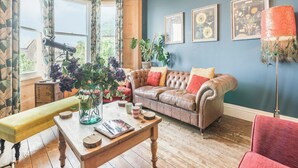 A cozy living room with a leather sofa, a wooden coffee table, and a bench.