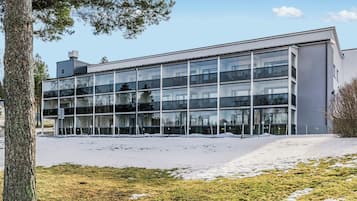 A modern building with multiple glass windows and a flat roof.