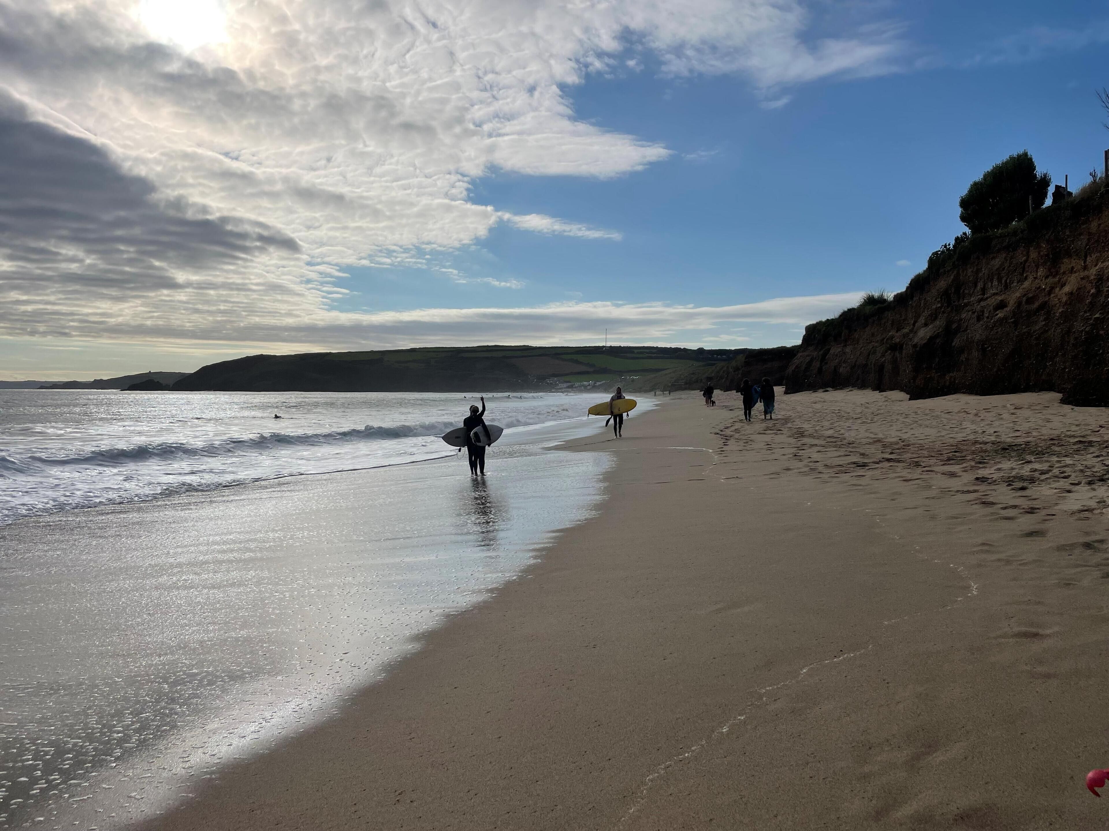 A beach with a clear sky and waves.