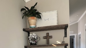 A kitchen with a coffee station, a potted plant, and a sign that reads "HOME Sweet HOME".