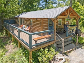 A rustic cabin with a deck, outdoor seating, and a stone fireplace. - Chickadee: Funky Mountain Stay @ Talking Water (Chattanooga)