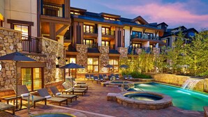 A pool and hot tub area with lounge chairs and a waterfall feature. - 2 BR 2 BA Unit in Vail Village Beautiful Sebastian Residence w 5 Star Amenities (Vail)