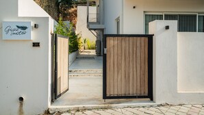 A gated entrance to a building with a sign for 'Gizzi Suites' and a number '25' on the wall. - Gizz Suites City (Fethiye)