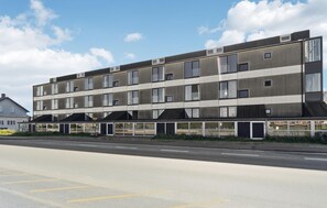 A multi-story building with a flat roof and large windows, likely a residential or office building. - 1 bedroom awesome apartment in Fanø (Fanø)