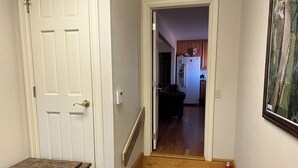 A staircase leading to a living area with a refrigerator and a painting on the wall. - Ben Ranch House overlooking river - Full 3 Bedroom house. Minutes from Fairfax. (Ralston)