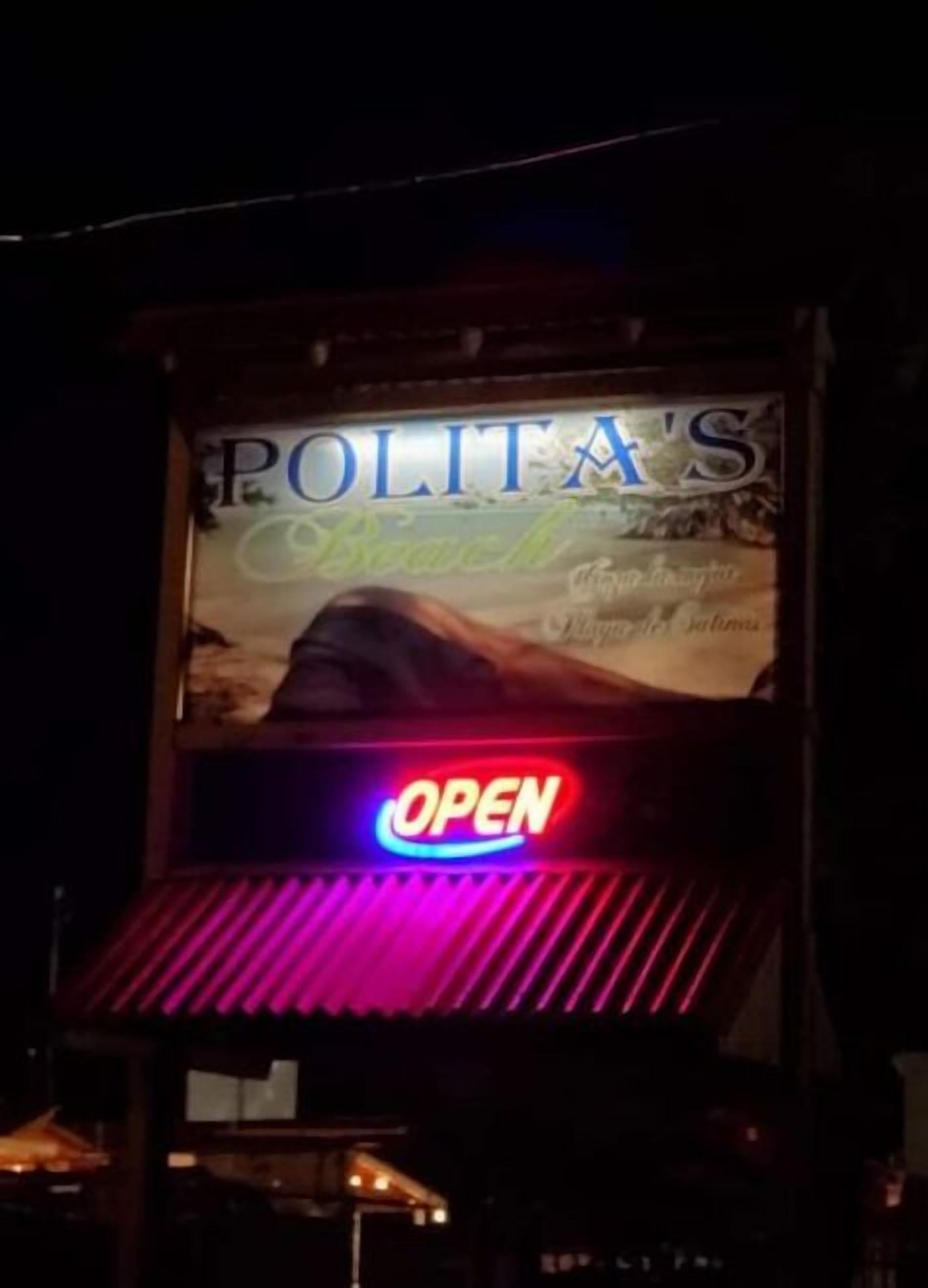 A sign for "POLITA'S" with a neon 'OPEN' sign below it.