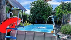 A swimming pool with a ladder, a red life ring, and a water pump. - Villa ático beach house,pool,wifi,Netflix,backyard (Salinas)